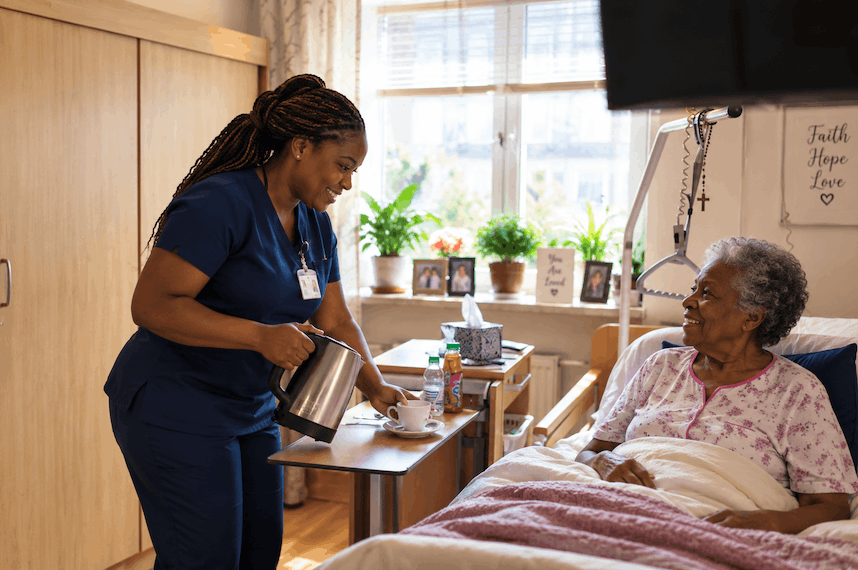 Nurse helping an older woman in her bedroom