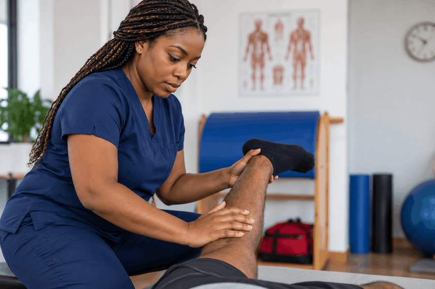 Physiotherapist treating a client’s knee