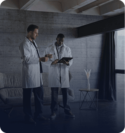 Two clinicians reviewing notes together