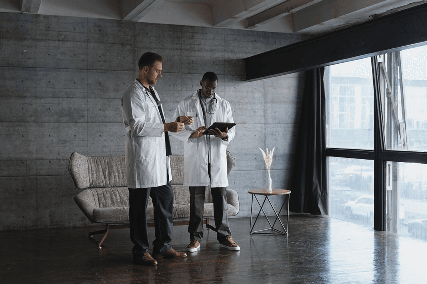 Two clinicians reviewing notes in an office