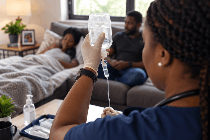 Nurse checking an IV drip for a client recovering at home