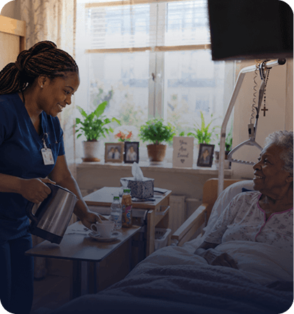 Nurse helping an older woman in her bedroom