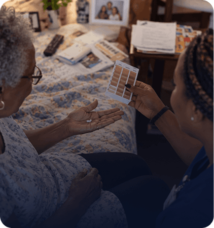 Nurse going through care notes with an older woman at home