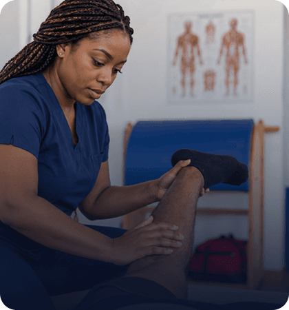 Physiotherapist treating a client’s knee