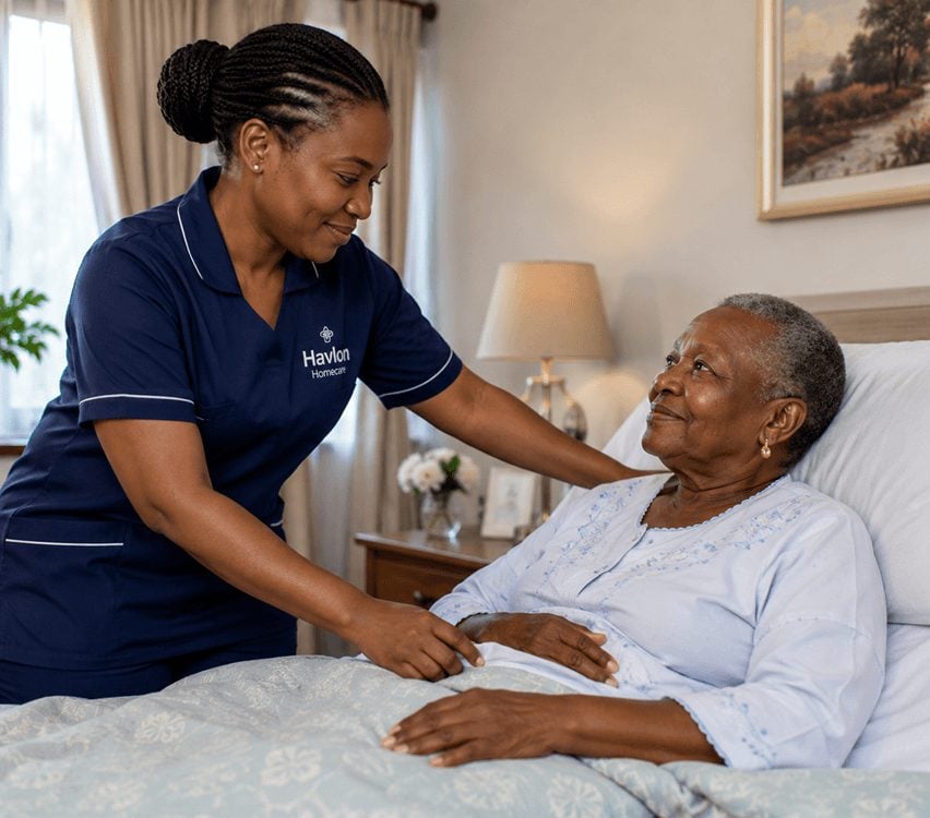 Caregiver supporting a senior woman sitting up in bed