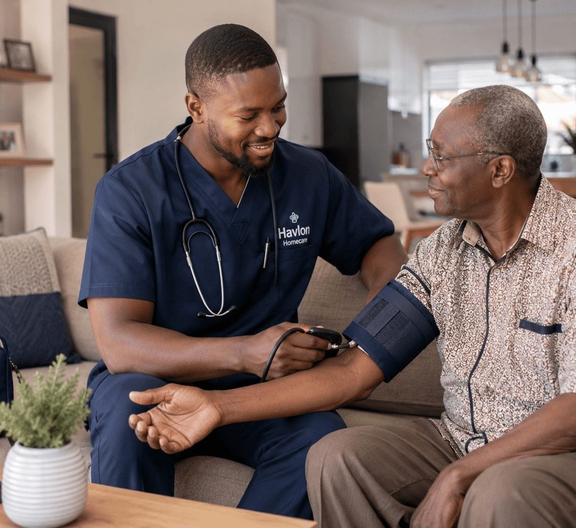 Havlon nurse checking an older man’s blood pressure at home